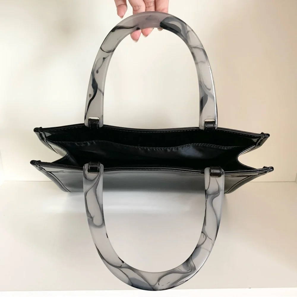 Hold NWOT Neiman Marcus black patent marble handle modern bag